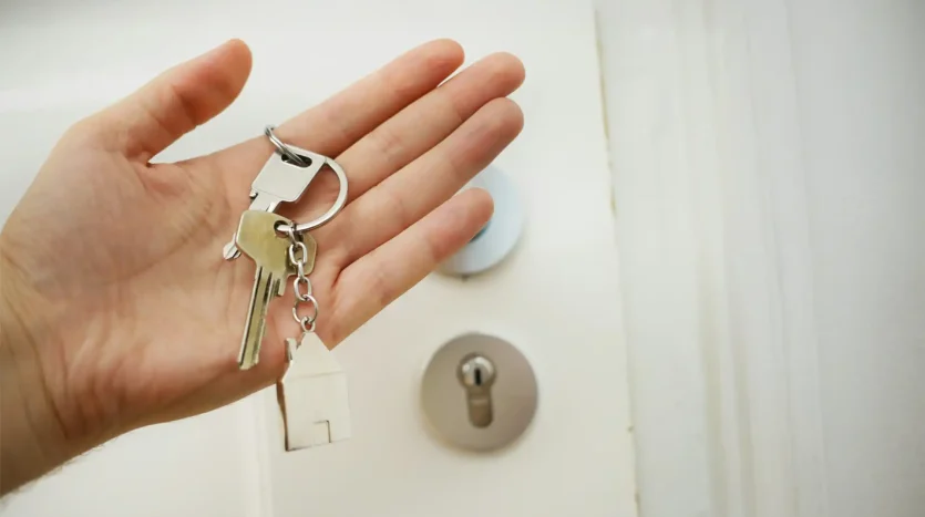 A hand delivering house keys